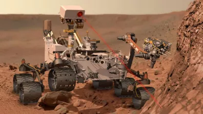 Vue d’artiste du rover Curiosity en train d’utiliser ChemCam, un spectromètre qui lui permet d’analyser la composition du sol martien à distance grâce à un laser.  Vue d’artiste du rover Curiosity en train d’utiliser ChemCam, un spectromètre qui lui permet d’analyser la composition du sol martien à distance grâce à un laser.